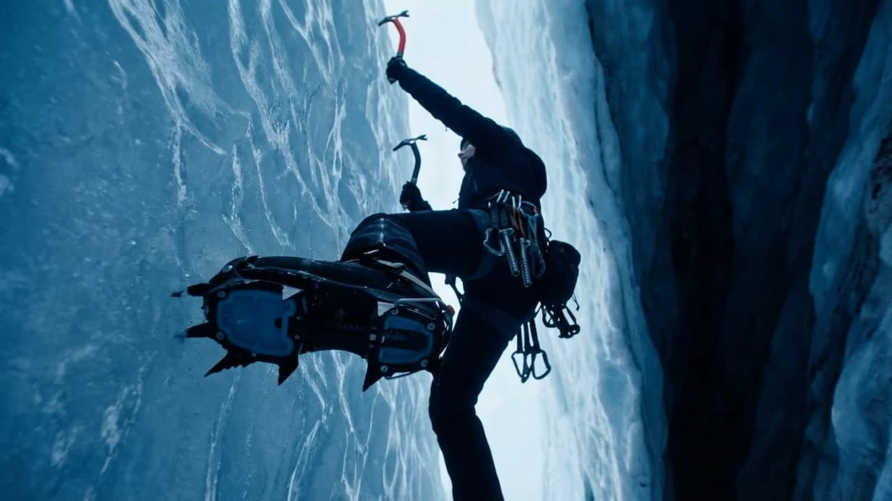 Ice climber ascending a blue glacial chamber