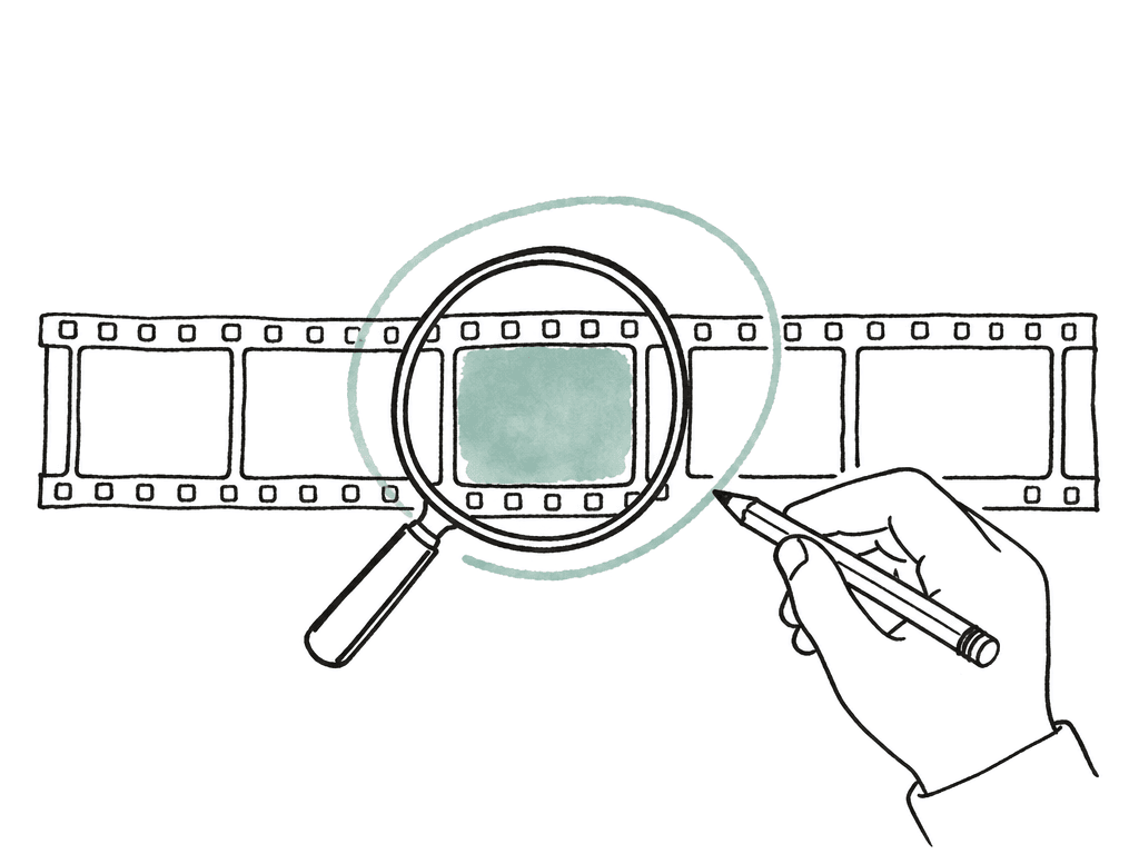 A filmstrip frame found by a magnifying glass is being marked by a human hand with a pencil, suggesting search plus review.