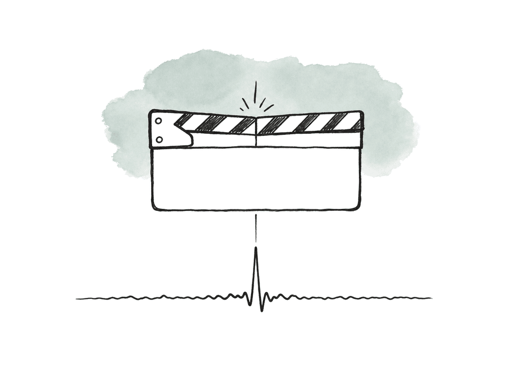 Closed clapper sticks aligned with a sharp waveform spike.